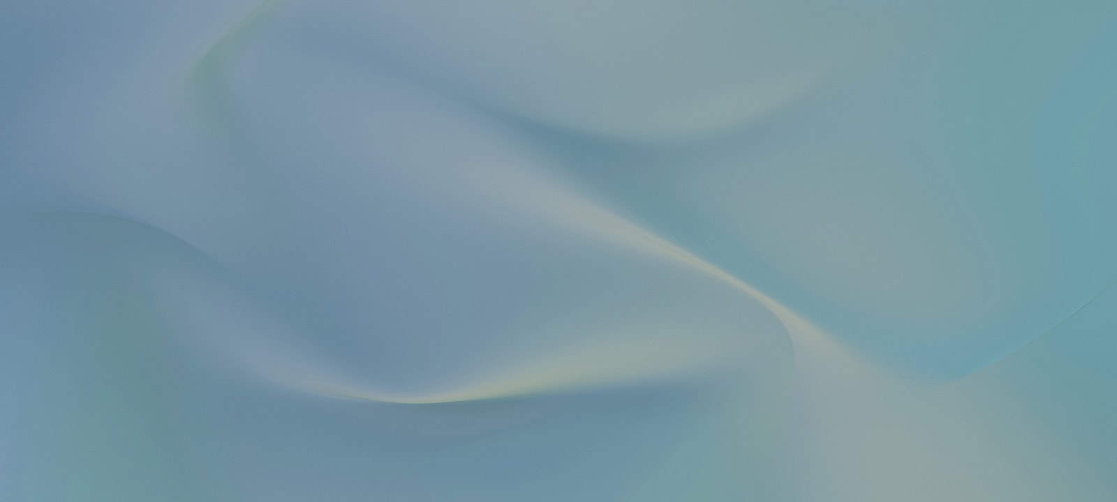 Smiling woman wearing glasses in a professional setting.